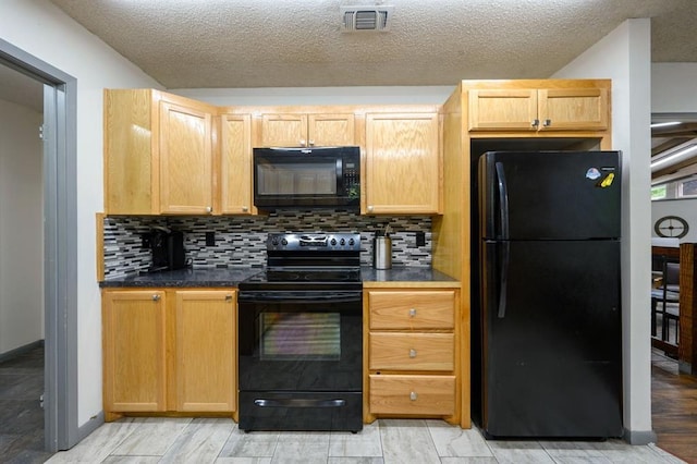 kitchen with decorative backsplash, light brown cabinets, black appliances, and a textured ceiling