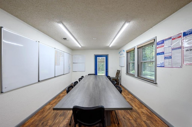 dining area with a textured ceiling and hardwood / wood-style flooring