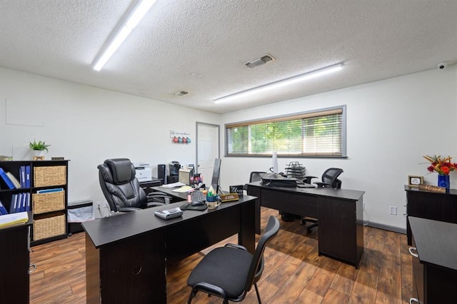 office area featuring a textured ceiling and dark hardwood / wood-style floors