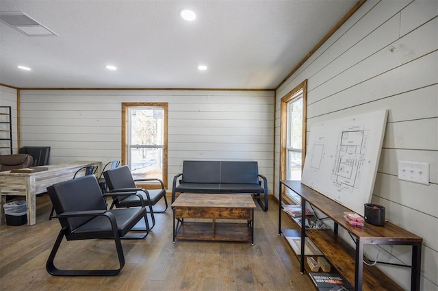 office featuring dark wood-type flooring, ornamental molding, and wooden walls