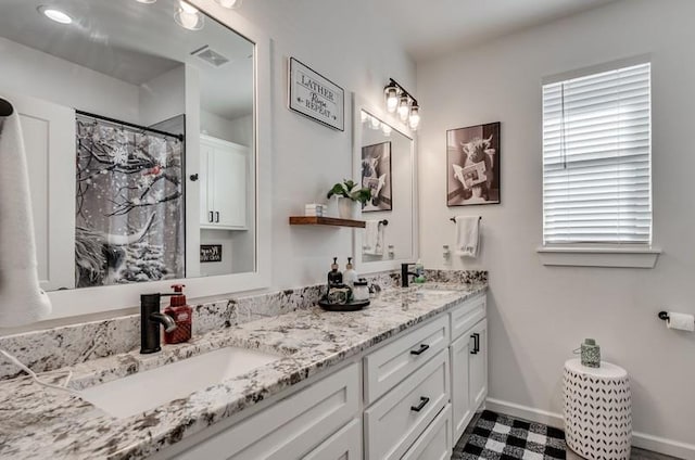 bathroom with walk in shower and vanity