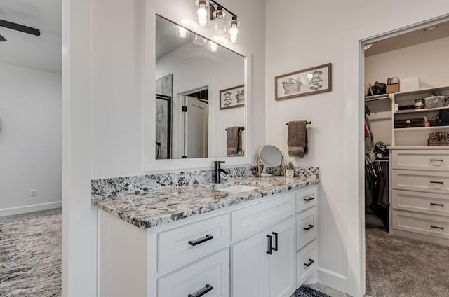 bathroom featuring ceiling fan and vanity