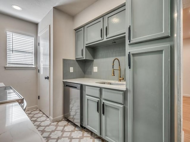 kitchen with dishwasher, decorative backsplash, sink, range with electric cooktop, and light stone counters