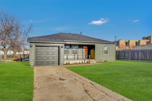 back of property featuring a lawn and a garage