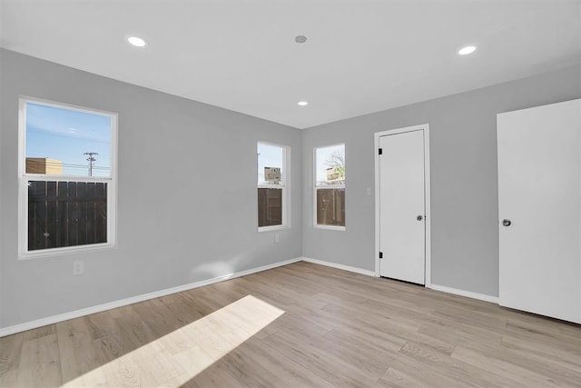 empty room with light hardwood / wood-style flooring