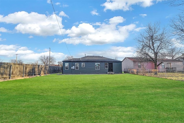 rear view of house featuring a lawn