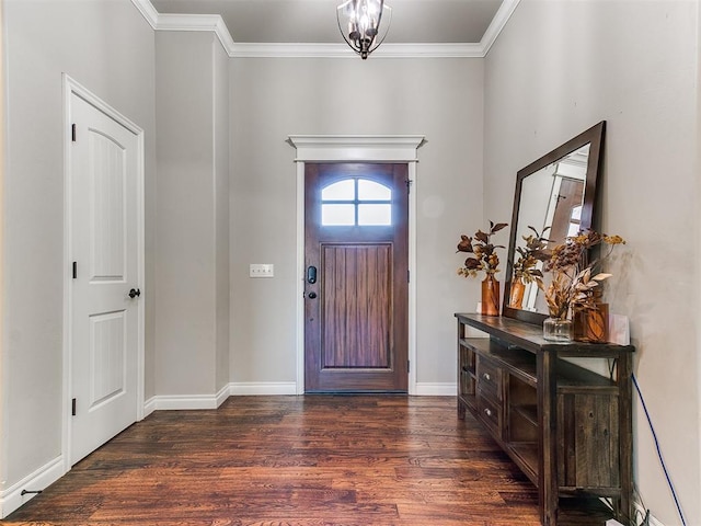 foyer featuring dark hardwood / wood-style flooring, an inviting chandelier, and crown molding