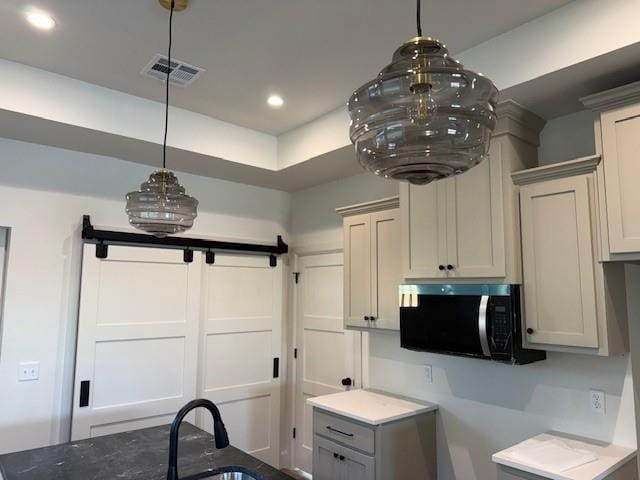 kitchen with sink, hanging light fixtures, and gray cabinetry