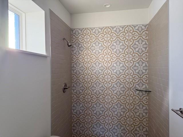 bathroom with tiled shower