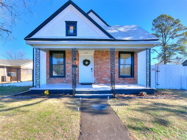 view of front of house featuring a porch and a front lawn