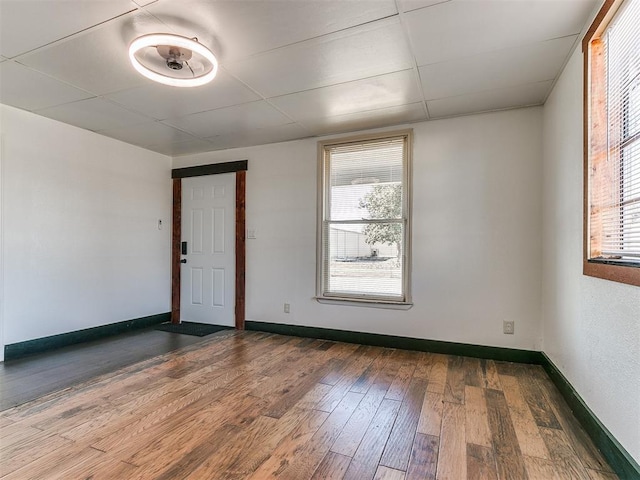 unfurnished room featuring plenty of natural light and hardwood / wood-style flooring