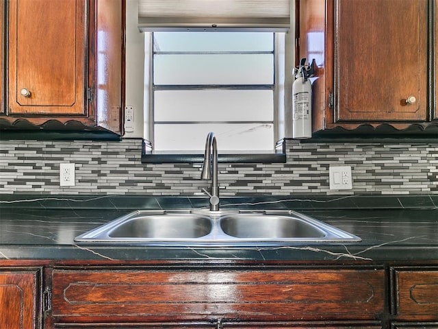 kitchen featuring backsplash and sink