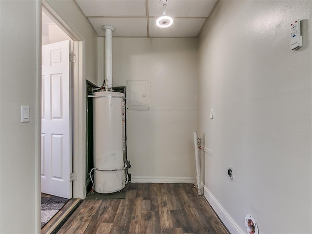 laundry room with water heater, dark wood-type flooring, and electric panel