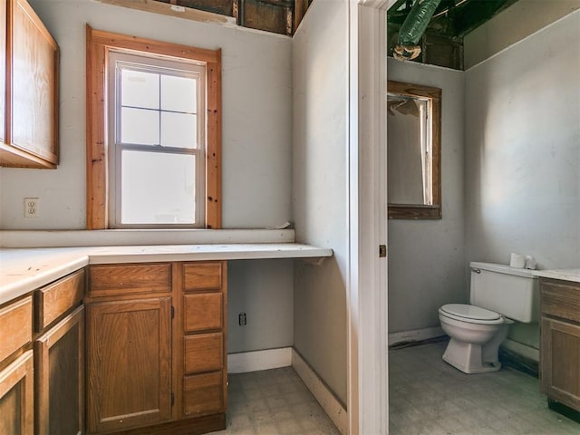 bathroom featuring toilet and vanity