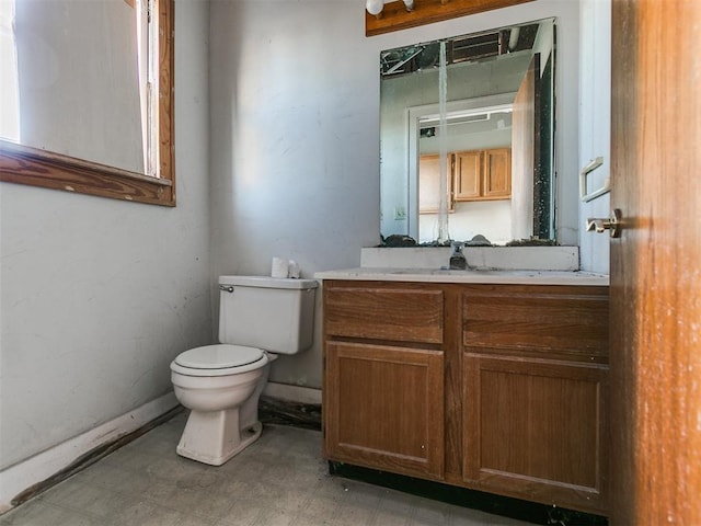 bathroom with toilet and vanity