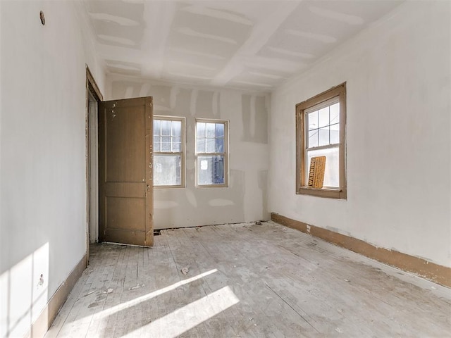 unfurnished room featuring plenty of natural light