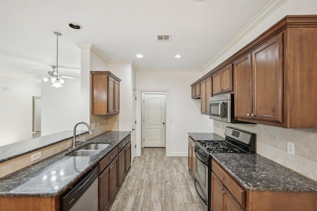 kitchen with kitchen peninsula, sink, light hardwood / wood-style flooring, appliances with stainless steel finishes, and ornamental molding