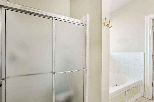 bathroom featuring tile patterned floors and independent shower and bath