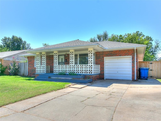 ranch-style home featuring a porch, a front lawn, and a garage