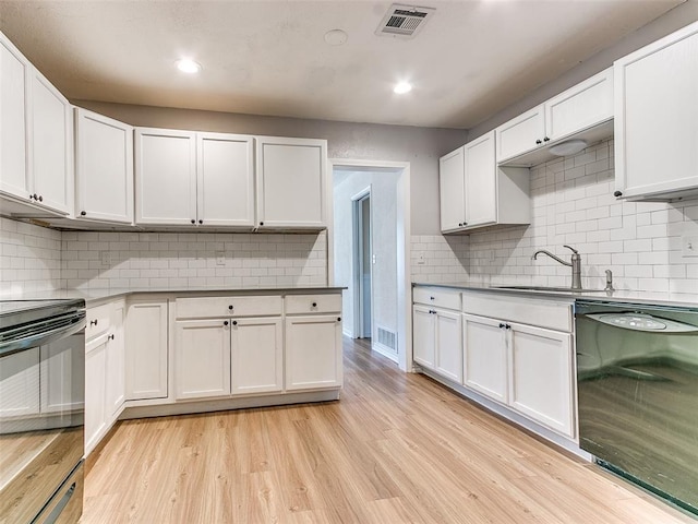 kitchen featuring white cabinets, light hardwood / wood-style floors, and black appliances