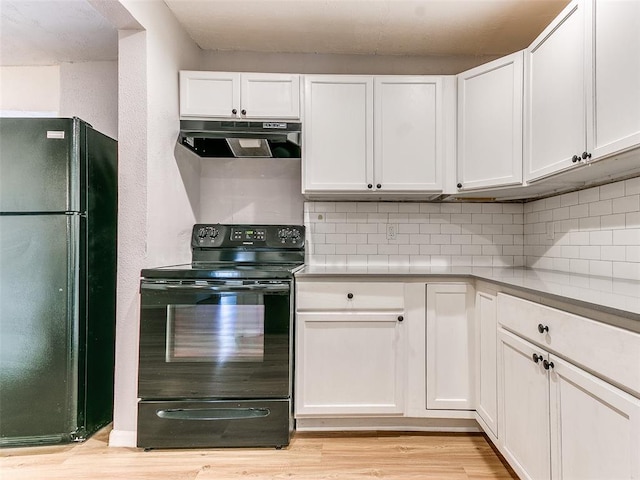 kitchen with black appliances, white cabinetry, backsplash, and light hardwood / wood-style floors