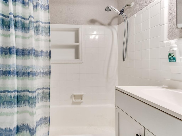 bathroom featuring shower / tub combo and vanity