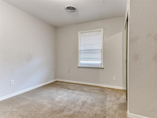 spare room featuring carpet