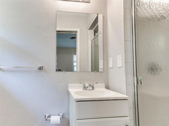 bathroom with an enclosed shower and vanity