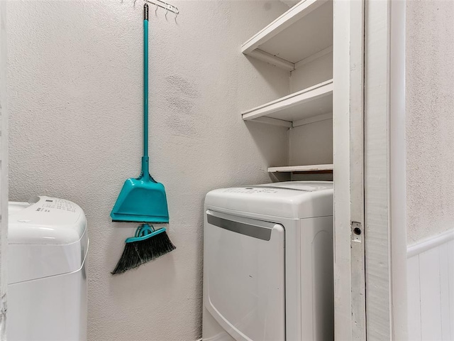 clothes washing area with washing machine and clothes dryer