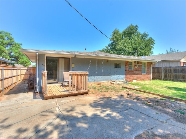 rear view of house featuring a yard and a patio area