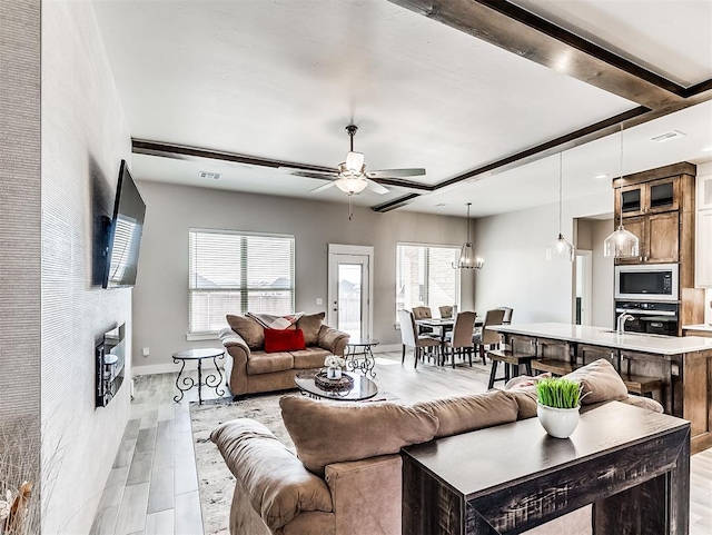 living room with ceiling fan and light hardwood / wood-style flooring