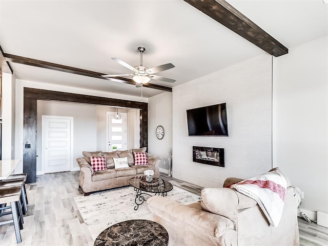 living room with light wood-type flooring and ceiling fan