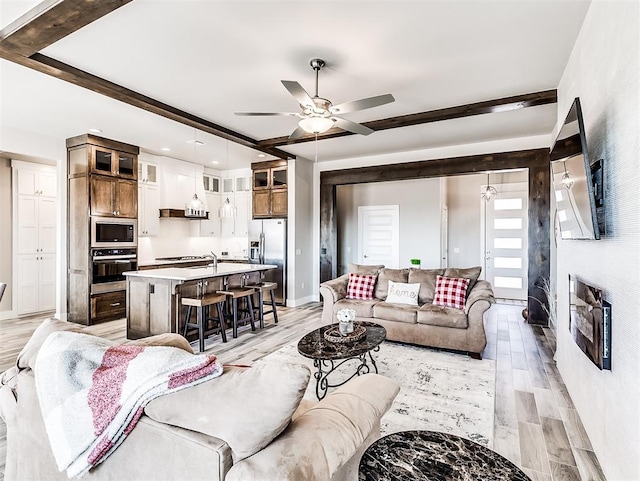 living room featuring ceiling fan and light hardwood / wood-style flooring