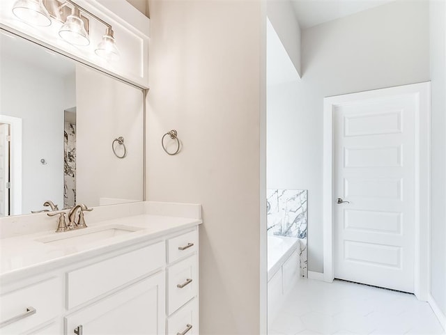 bathroom featuring tile patterned flooring, vanity, and a bathtub