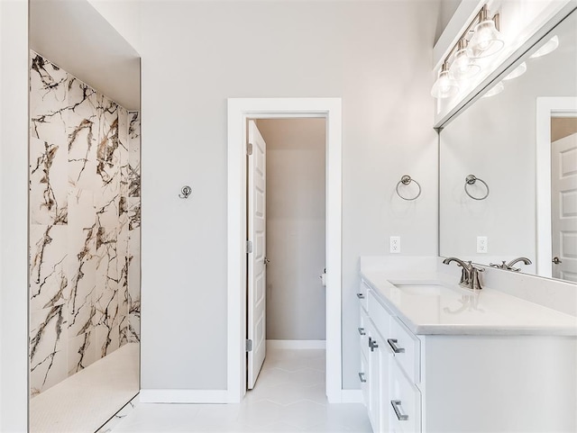 bathroom featuring vanity, tile patterned flooring, and a shower