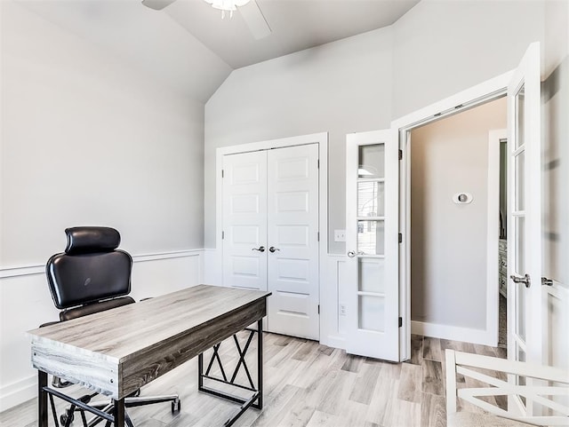 office with vaulted ceiling, ceiling fan, and light hardwood / wood-style flooring