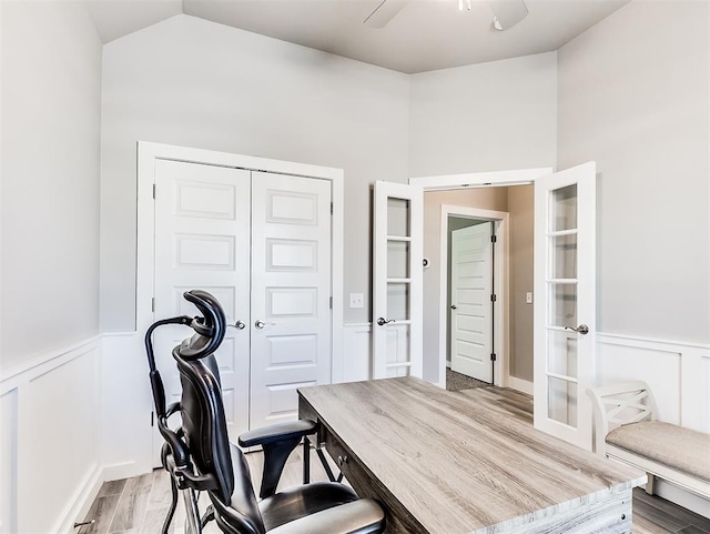 office area with vaulted ceiling, french doors, and light wood-type flooring