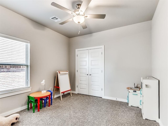 rec room with carpet floors, a healthy amount of sunlight, and ceiling fan