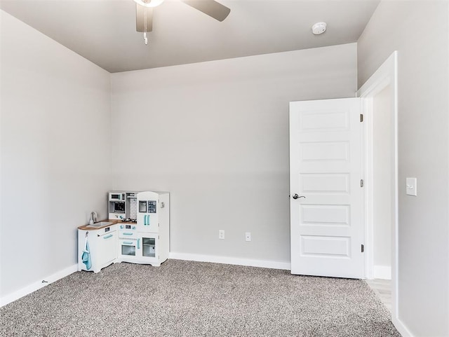 interior space featuring ceiling fan and carpet flooring