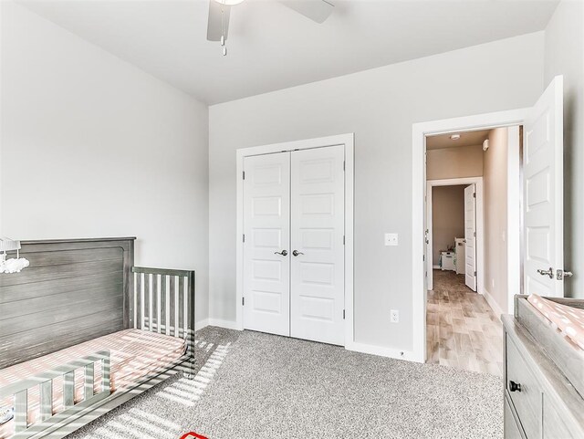 unfurnished bedroom featuring light carpet, ceiling fan, and a closet