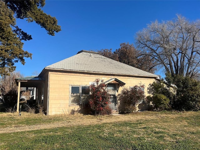 view of side of property with a yard