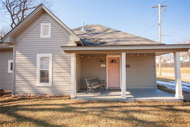 view of front of house with a porch and a front lawn