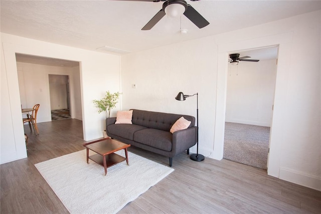 living room with ceiling fan and hardwood / wood-style flooring