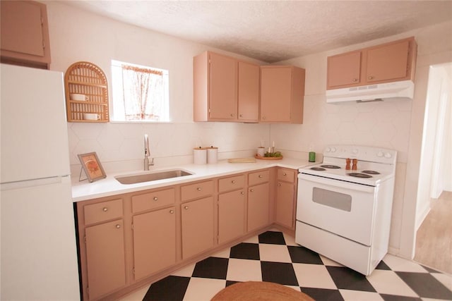 kitchen with sink, light brown cabinets, white appliances, and a textured ceiling