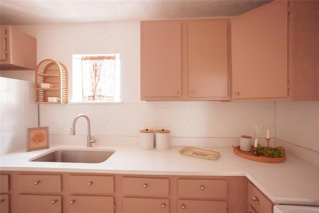 kitchen with sink, decorative backsplash, and light brown cabinets