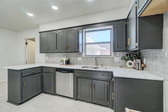 kitchen featuring gray cabinetry, light tile patterned floors, sink, stainless steel dishwasher, and tasteful backsplash