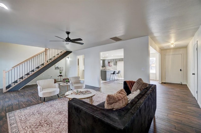 living room with hardwood / wood-style floors and ceiling fan