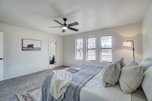 bedroom featuring ensuite bathroom, ceiling fan, and light carpet