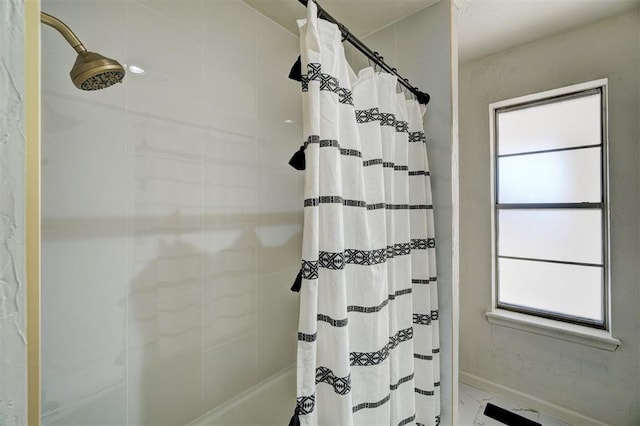 bathroom with a shower with curtain and a healthy amount of sunlight