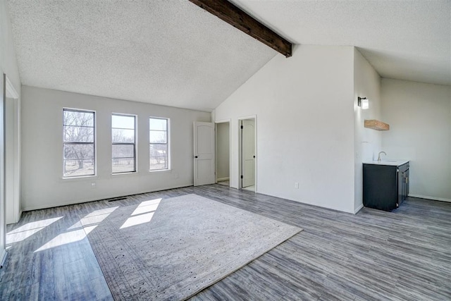 interior space featuring a textured ceiling, light hardwood / wood-style flooring, and sink